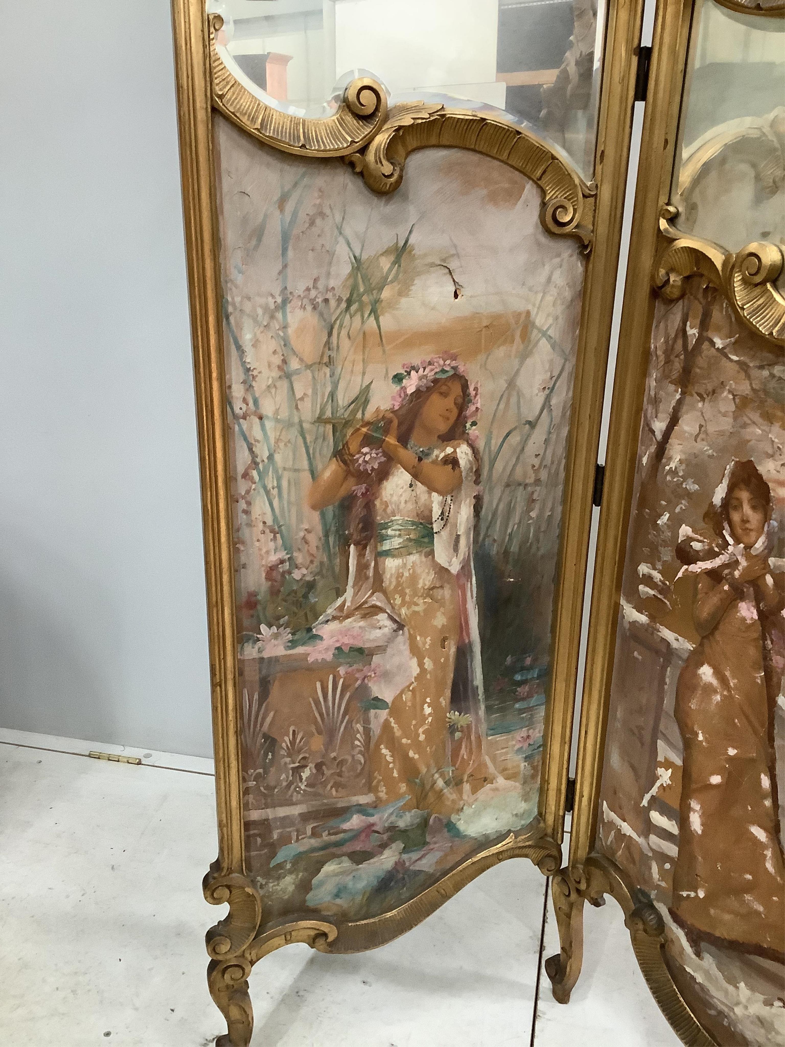 An early 20th century French carved giltwood three fold dressing screen with inset painted and printed panels, width 48cm, height 159cm. Condition - fair but some denting to the panels